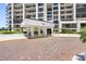 Brick paved entryway to the building with porte-cochere at 8 Belleview Blvd # 203, Belleair, FL 33756