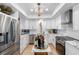 Bright kitchen featuring white cabinets, stainless steel appliances, and an island at 8 Belleview Blvd # 203, Belleair, FL 33756