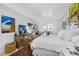 Spacious bedroom featuring a king-size bed and access to a private balcony at 8 Belleview Blvd # 203, Belleair, FL 33756