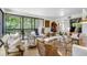 Sunlit living room with multiple seating areas and access to a balcony at 8 Belleview Blvd # 203, Belleair, FL 33756