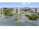 Aerial view of waterfront community with pool and lush landscaping at 8 Belleview Blvd # 203, Belleair, FL 33756