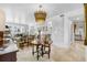 Spacious dining room with a large chandelier and hardwood floors at 8 Belleview Blvd # 203, Belleair, FL 33756