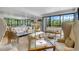Elegant living room featuring large windows, high ceilings and stylish furniture at 8 Belleview Blvd # 203, Belleair, FL 33756