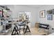 Well-lit home office with a glass-top desk and modern shelving at 8 Belleview Blvd # 203, Belleair, FL 33756