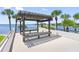Relaxing waterfront patio with pergola and seating, offering scenic views at 8 Belleview Blvd # 203, Belleair, FL 33756