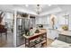 Modern white kitchen with stainless steel appliances and marble countertops at 8 Belleview Blvd # 203, Belleair, FL 33756