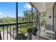 Private screened balcony overlooking lush landscaping and a pond at 8 Belleview Blvd # 203, Belleair, FL 33756