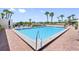 Community pool with brick patio and lounge chairs at 8 Belleview Blvd # 203, Belleair, FL 33756