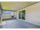 Screened porch with sliding glass doors leading to backyard at 5713 Ridgestone Dr, Tampa, FL 33625