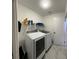 Convenient laundry room with washer, dryer, and shelving at 2706 Falling Leaves Dr, Valrico, FL 33596