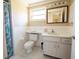 Cozy bathroom with white tile, ample counter space, and shower at 12210 Buttonwood Row, Hudson, FL 34667