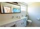 Bright bathroom featuring a large vanity, tiled wall, and a framed mirror at 12210 Buttonwood Row, Hudson, FL 34667