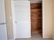 A large closet featuring wooden panelling in the back, and bright, louvered doors at 12210 Buttonwood Row, Hudson, FL 34667