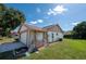 Exterior view of the house showing the garage, side yard, and backyard area at 12210 Buttonwood Row, Hudson, FL 34667