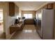 Functional kitchen with stainless steel refrigerator and granite countertops at 12210 Buttonwood Row, Hudson, FL 34667