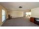 A spacious living room boasts neutral walls and plush carpeting at 12210 Buttonwood Row, Hudson, FL 34667