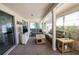 Enclosed sunroom featuring neutral decor, large windows, and plush carpeting at 12210 Buttonwood Row, Hudson, FL 34667