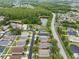 Aerial view of the property's location within a residential area, highlighting its proximity to a road and green space at 30735 Lanesborough Cir, Wesley Chapel, FL 33543