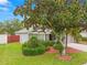 Charming single-story home with mature trees, beautiful landscaping, and a two-car garage at 30735 Lanesborough Cir, Wesley Chapel, FL 33543