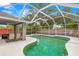 Inviting screened-in pool with a spa and ample space for outdoor enjoyment at 30735 Lanesborough Cir, Wesley Chapel, FL 33543