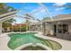 Inviting screened-in pool with a spa and ample space for outdoor enjoyment at 30735 Lanesborough Cir, Wesley Chapel, FL 33543