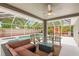 Relaxing screened-in patio with comfortable seating overlooking a pool and spa at 30735 Lanesborough Cir, Wesley Chapel, FL 33543
