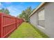 Grassy side yard with a privacy fence, providing a secure and private outdoor space at 30735 Lanesborough Cir, Wesley Chapel, FL 33543