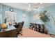Bright home office with built-in shelving and a large desk at 30735 Lanesborough Cir, Wesley Chapel, FL 33543