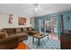 Living room boasts a sectional sofa and access to the patio at 30735 Lanesborough Cir, Wesley Chapel, FL 33543