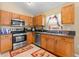 Kitchen boasts wood cabinets, stainless steel appliances and granite countertops at 30735 Lanesborough Cir, Wesley Chapel, FL 33543