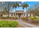 Community clubhouse with palm trees and well-maintained landscaping at 30735 Lanesborough Cir, Wesley Chapel, FL 33543