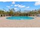 Circular community pool with surrounding patio and shade structures at 30735 Lanesborough Cir, Wesley Chapel, FL 33543