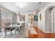Dining room with hardwood floors, gray chairs and a glass-top table at 30735 Lanesborough Cir, Wesley Chapel, FL 33543