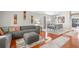 Open concept living and dining area with hardwood floors, gray sofa and a formal dining set at 30735 Lanesborough Cir, Wesley Chapel, FL 33543