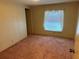 Simple bedroom with pink carpet and a window at 34303 Lodge Dr, Wesley Chapel, FL 33543