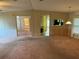 Spacious living room with carpeted floor and view to kitchen at 34303 Lodge Dr, Wesley Chapel, FL 33543