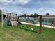 Wooden playground structure with swings near a pool at 34303 Lodge Dr, Wesley Chapel, FL 33543