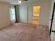 Bright bedroom with carpet and ensuite bathroom at 34303 Lodge Dr, Wesley Chapel, FL 33543