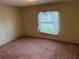 Simple bedroom with carpeted floor and window at 34303 Lodge Dr, Wesley Chapel, FL 33543