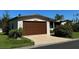 Manufactured home's attached garage with brown overhead door at 34303 Lodge Dr, Wesley Chapel, FL 33543