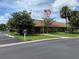 Community building with American flag and landscaping at 34303 Lodge Dr, Wesley Chapel, FL 33543