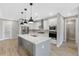 Modern kitchen with a large island, white cabinets, and quartz countertops at 4080 Southern Valley Loop, Brooksville, FL 34601