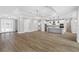 Open-concept living room and kitchen with hardwood floors and modern lighting at 4080 Southern Valley Loop, Brooksville, FL 34601
