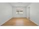 Bright dining room with light hardwood floors and modern light fixture at 18051 Java Isle Dr, Tampa, FL 33647