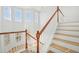 Elegant staircase with wood railings and light hardwood floors at 18051 Java Isle Dr, Tampa, FL 33647