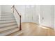 Light-filled entryway showcasing a staircase and wood flooring at 18051 Java Isle Dr, Tampa, FL 33647