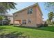 Two-story house with backyard, covered patio, and green lawn at 18051 Java Isle Dr, Tampa, FL 33647