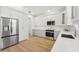 Modern kitchen with white cabinets, stainless steel appliances and quartz countertops at 18051 Java Isle Dr, Tampa, FL 33647