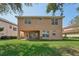 Two-story house with a spacious backyard and covered patio at 18051 Java Isle Dr, Tampa, FL 33647