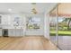 Bright dining room with sliding doors to patio and lake view at 18051 Java Isle Dr, Tampa, FL 33647